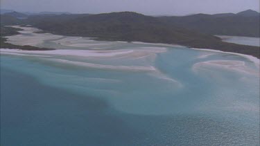 aerials over reef island and river mouth with white sands close to Whitehaven beach