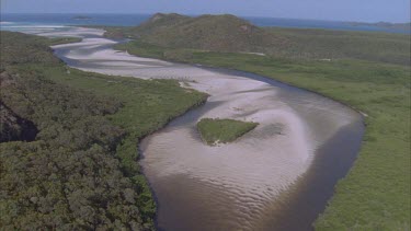 aerials over river mouth with white sands and mangroves close to Whitehaven beach