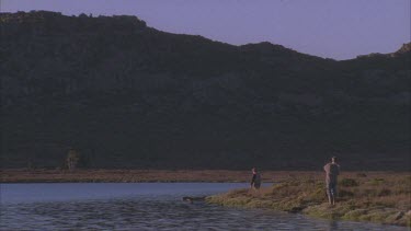 trout fishing at edge of Lake fly fishing