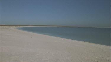 sandy beach Hamelin pool running into Sharks Bay , shows waters edge , Shell Beach