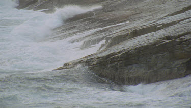 sea rolling in over rocks waves