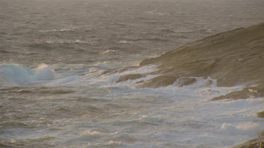 sea rolling in over rocks mist waves