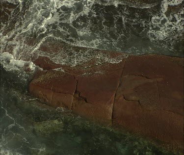 Waves, rocks erosion. Waves washing over rocks.