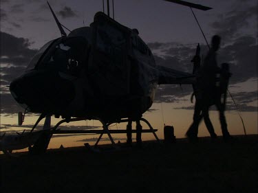 Unloading a helicopter at dusk