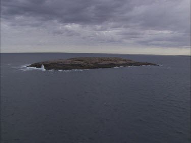 View around a large rock in the ocean