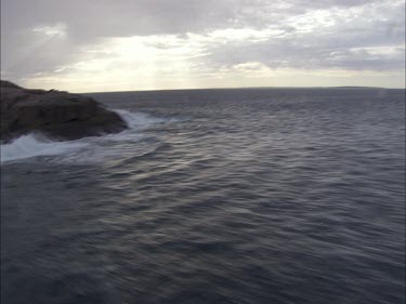 View around a large rock in the ocean