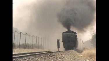 Steam train passes camera.