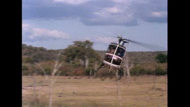 Helicopter flying low over ground