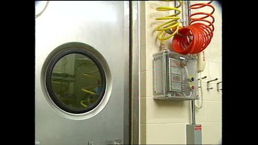 man in chemical suit presses button to enter secure room
