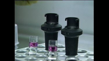 Places chemicals in test tube into centrifuge containers