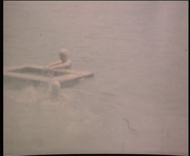 women on floating platform wearing swimming caps