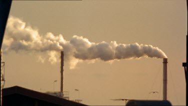 Industrial smoke rises from a factory