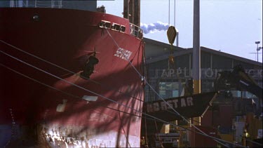 Docked ship loads cargo onto deck