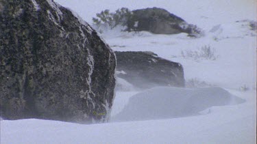 Snow at base of rocks