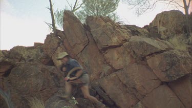 men, jump out from behind rocks and view of legs as they run