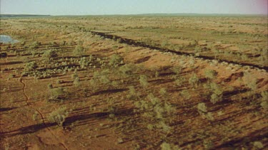 shot of desert landscape, waterhole in distance