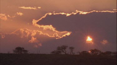 sunset, sun peeking through clouds