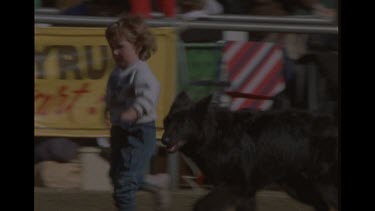 Small Child Running With Her Dog At Fair