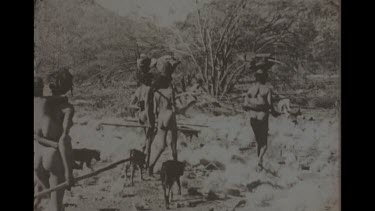 Black And White Shot Of Aboriginal Women. Child And Dingo