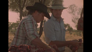 Two Outback Farmers Cutting Up Carcasses