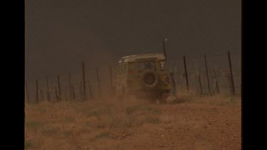 4WD Car Driving Alongside Dingo Fence In The Australian Outback
