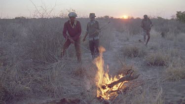 bushmen hunters starting fire .trying to get warthog out of hole by starting fire