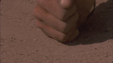 bushman children fingers making prints in sand