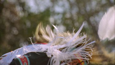 Indian Pow Wow, tribal dance in full regalia, feathers, colour, masks, use of tribal objects