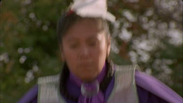 various shots: North American Indian women dancers in colourful, beaded regalia, shot at high speed