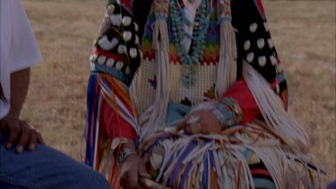 various shots: cu woman singing, feather in hair, jeweler.