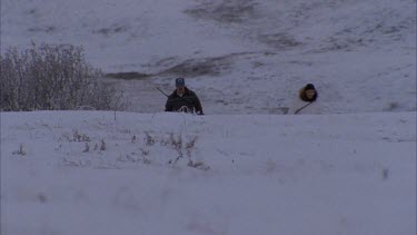 Each Inuit looking into distance