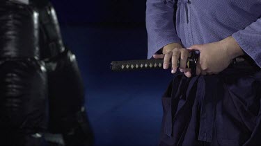 Man puting Sword back into holster_CU_Waist shot_3/4 angle