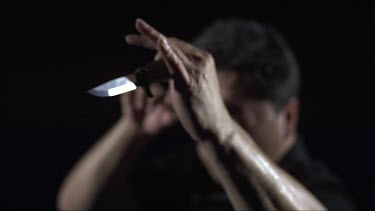 Man sparing with a knife_CU_Knife in focus_Slo Mo