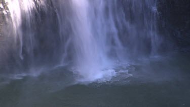 CU waterfall spray mist pouring into waterhole fresh