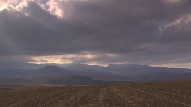 WS landscape pan across dark clouds light spiritual  clouds barren arid open plains savannah mountains