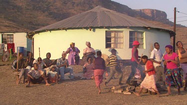 villagers local tribe woman children family clapping dancing rejoicing festivities gathering campfire day