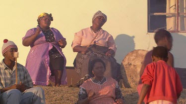 villagers local tribe woman children family clapping dancing rejoicing festivities gathering campfire day