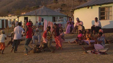 villagers local tribe woman children family clapping dancing rejoicing festivities gathering campfire day