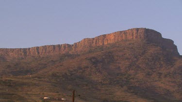 landscape arid cliff ledge mountain village villagers tribe group family human singing dancing running chanting campfire festival celebrations happy day