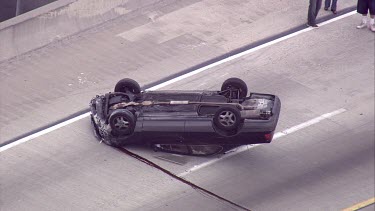 Upturned car accident on spaghetti juntion highway, Los Angeles. Traffic jam.