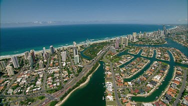 Gold Coast, Queensland. Mansions along canals and skyscrapers, hotels along beach. Surfers Paradise