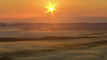 Montage. Sunset, clouds and mist. Rolling hills. Lighthouse; coast; Sydney city from South. Skyline. Mist.