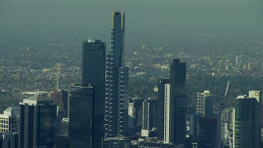 Aerial. Melbourne. City skyline and Yarra river. Bridges. Office blocks, towers.