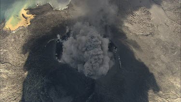 Active volcano steaming, smoke. Caldera. Recent lava flows have cooled and solidified around the cone. An eruption probably tore the top of the volcano off and created the caldera. Ash.