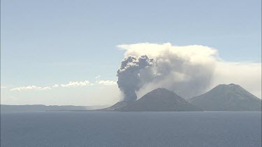 Wideshot Rabaul Volcano Papua New Guinea. From sea. Volcanic Eruption steam and smoke rising.