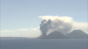 Wideshot Rabaul Volcano Papua New Guinea. From sea. Volcanic Eruption steam and smoke rising.