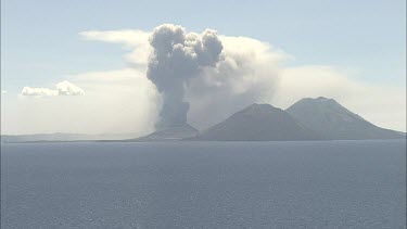 Wideshot Rabaul Volcano Papua New Guinea. From sea. Volcanic Eruption steam and smoke rising.