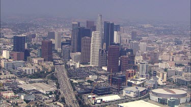Los Angeles; LA. City skyline. Office towers, office blocks. Skyscrapers; architecture. Roads and traffic. Spaghetti junctions and highways. Lots of cars. CBD
