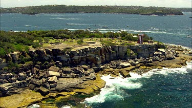 Sydney to Hobart Yacht race. Sydney Harbour. North Head, heading out to sea. South Head Lighthouse with city in background.