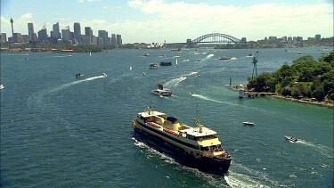 Sydney Harbour. Busy harbour scene with ferry and lots of boats. Harbour Bridge, city CBD and opera house in background. Circular Quay. Sydney Ferry on harbour.